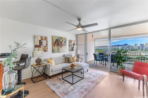 a living room with furniture a lamp and a floor to ceiling window