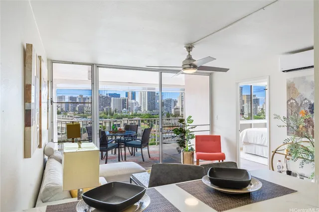 a living room with furniture and a floor to ceiling window