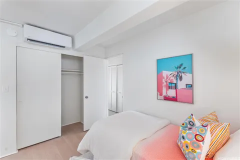 a bedroom with a bed and a painting on the wall