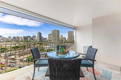 a dining room with furniture and a floor to ceiling window