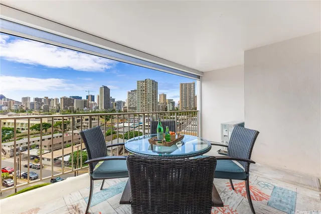 a dining room with furniture and a floor to ceiling window