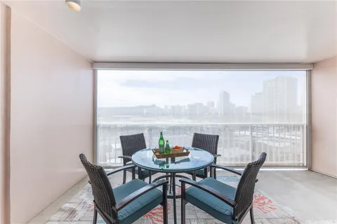 a view of a dining room with furniture and window
