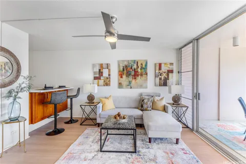 a living room with furniture a rug and a window