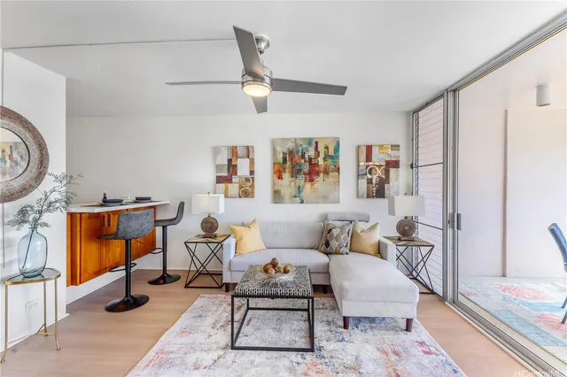 a living room with furniture a rug and a window