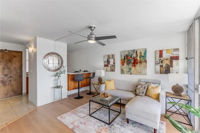 a living room with furniture a rug and a window