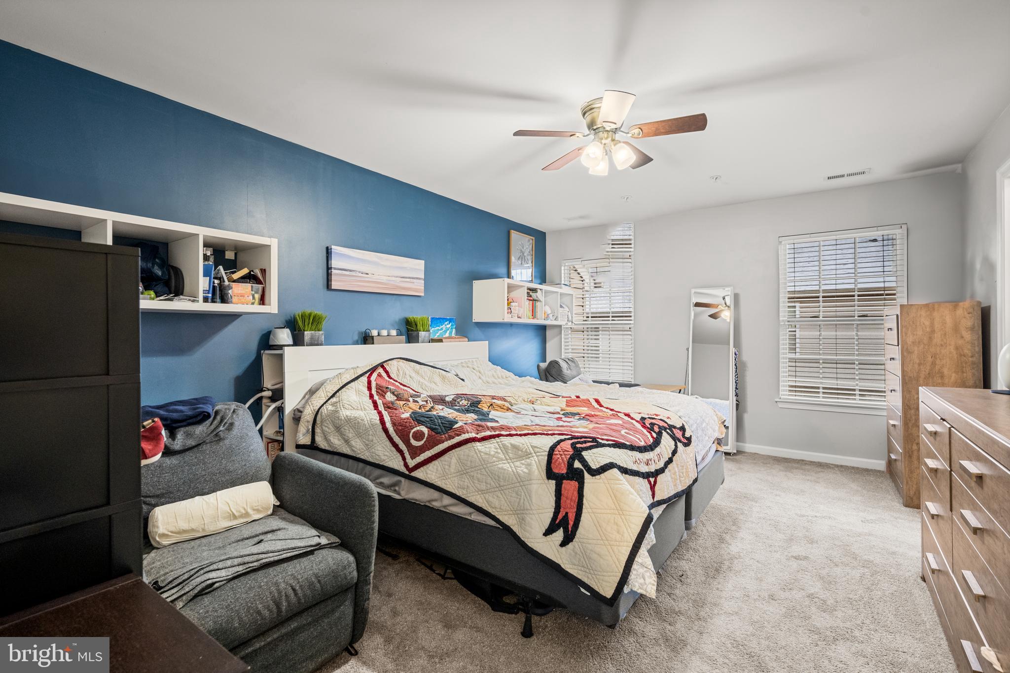 8020 Wright Place Shady Side, MD 20764 - Photo 12 of 21 a bedroom with a bed and a chandelier