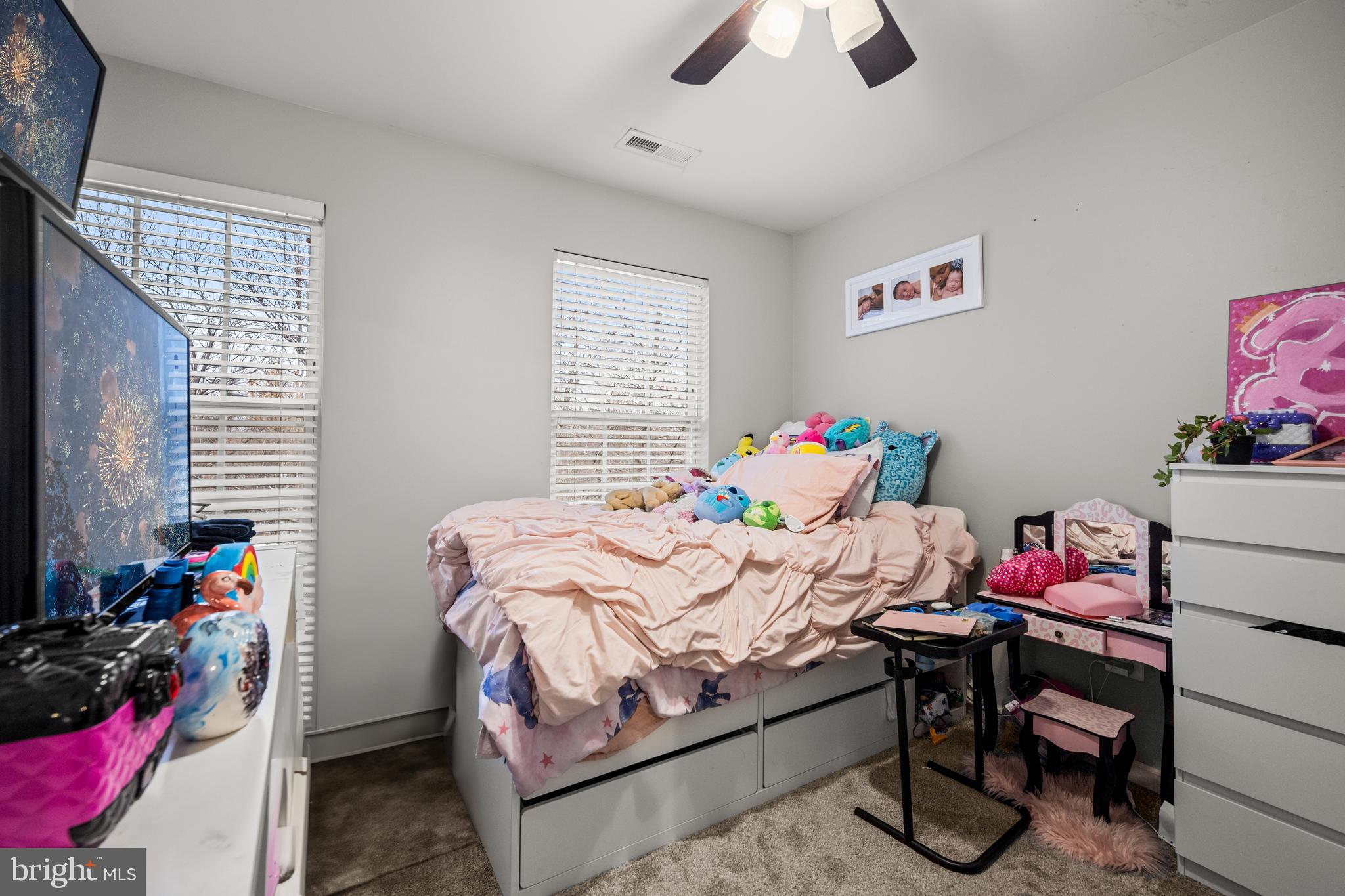 8020 Wright Place Shady Side, MD 20764 - Photo 16 of 21 a bedroom with a bed and a window
