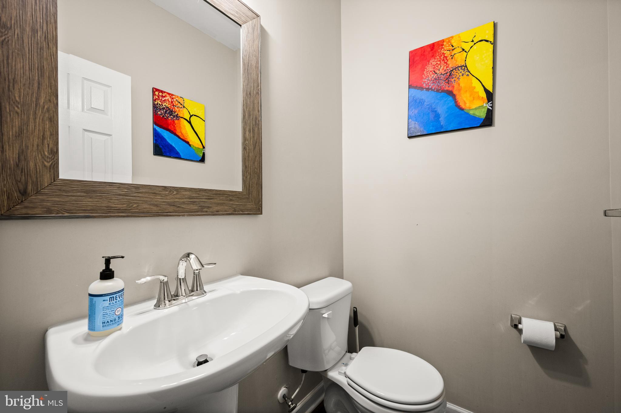 8020 Wright Place Shady Side, MD 20764 - Photo 18 of 21 a bathroom with a toilet sink and mirror
