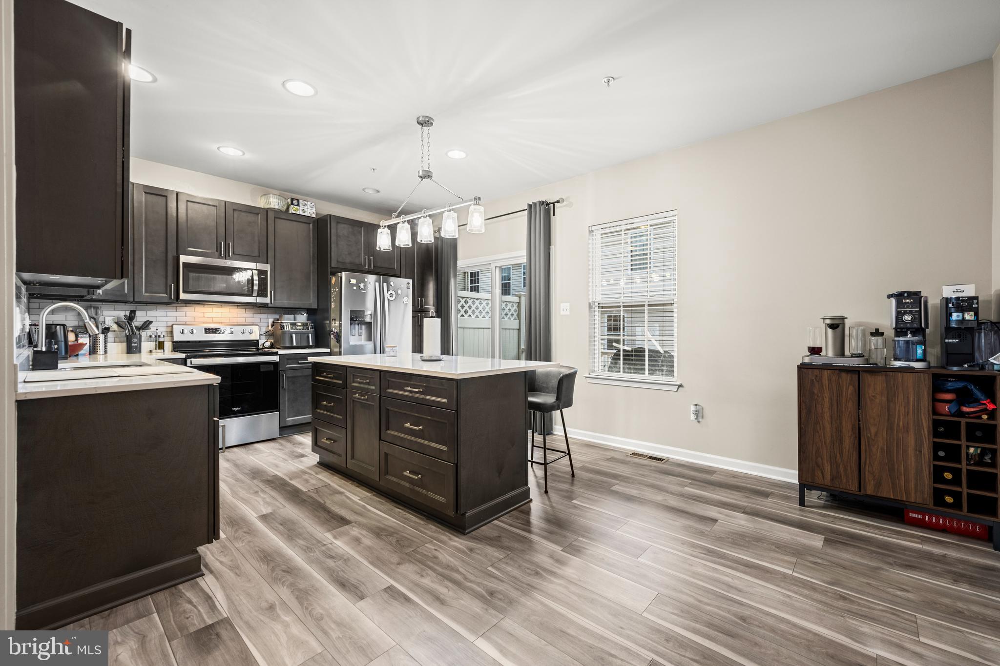 8020 Wright Place Shady Side, MD 20764 - Photo 5 of 21 a kitchen with stainless steel appliances granite countertop a stove a sink and a refrigerator