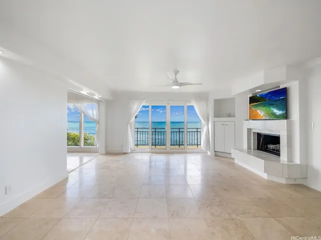 an empty room with furniture and a fireplace