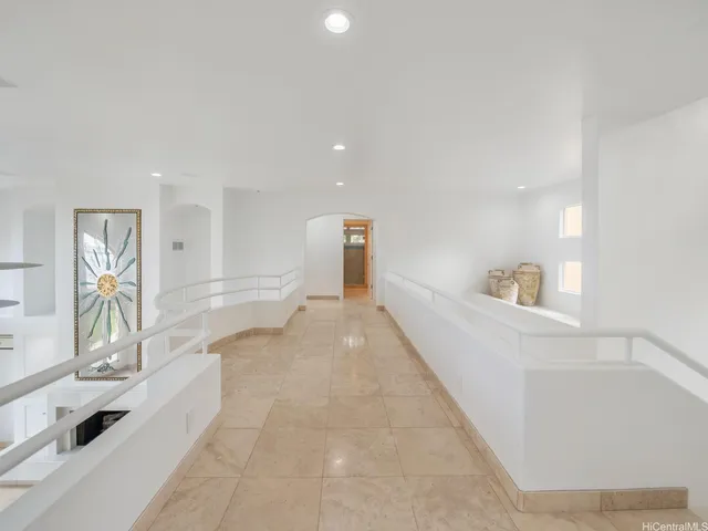 a view of hallway with furniture and a chandelier