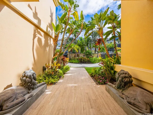 a view of a pathway with a flower garden