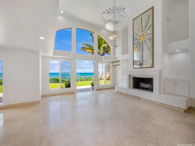a view of an empty room with a fireplace and a window
