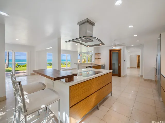 a kitchen with stainless steel appliances granite countertop a sink and a stove