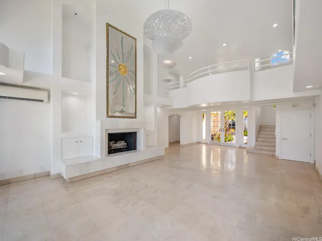a view of an empty room with a fireplace and a window