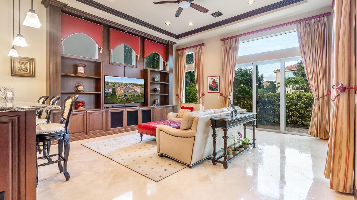 17384 Vistancia Circle Boca Raton, FL 33496 - Photo 11 of 27 a living room with furniture a floor to ceiling window and a flat screen tv