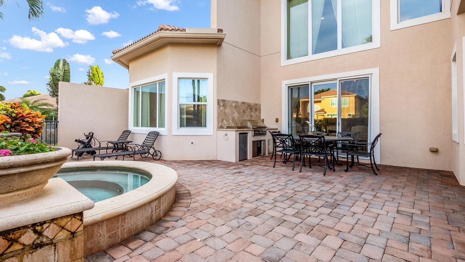 17384 Vistancia Circle Boca Raton, FL 33496 - Photo 23 of 27 a view of a dinning table and chairs in patio of the house