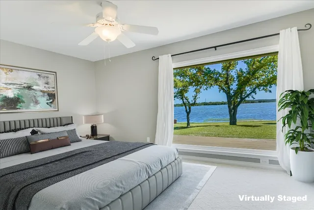 a bedroom with a large bed and a large window