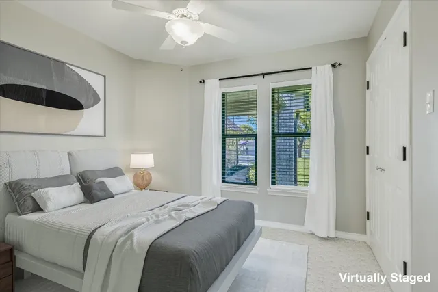 a bedroom with a large bed and a large window