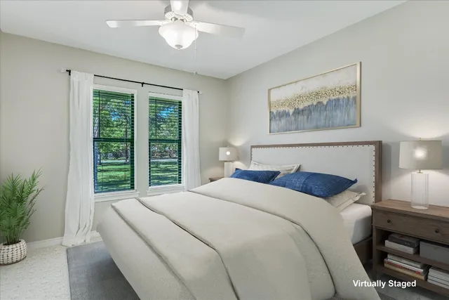 a bedroom with a bed and a potted plant