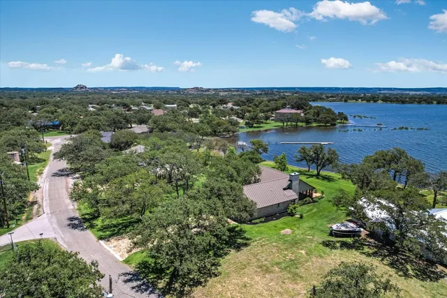 an aerial view of a houses with a lake view
