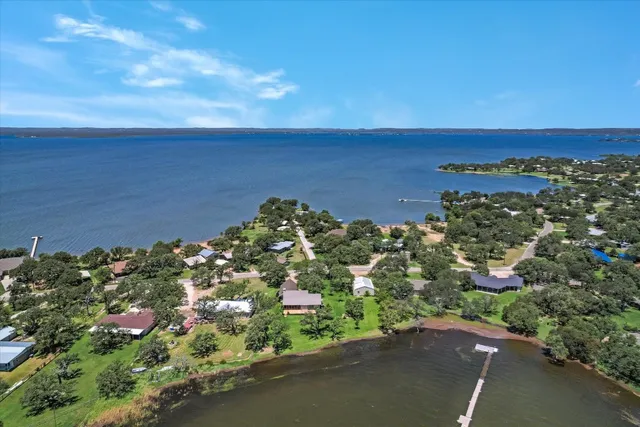 an aerial view of a houses with a yard