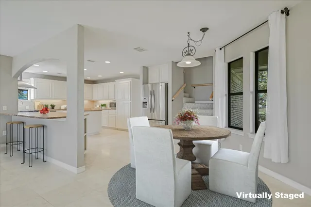 a dining room with furniture and a chandelier