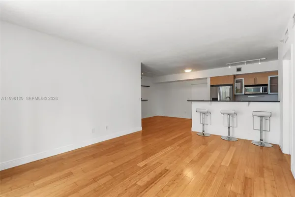 a view of a kitchen with a sink and a refrigerator