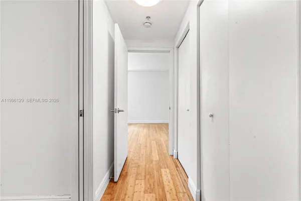 a view of a hallway with wooden floor