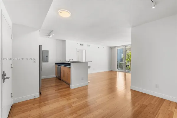a view of kitchen with furniture and wooden floor