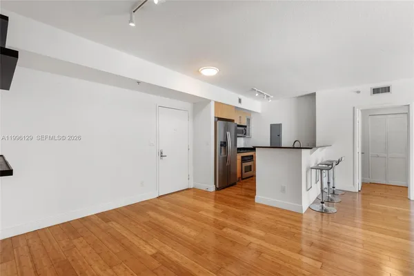 a view of a kitchen with wooden floor