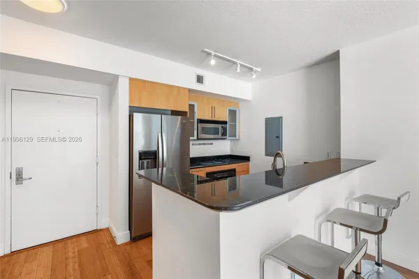 a kitchen with stainless steel appliances a refrigerator and a stove top oven