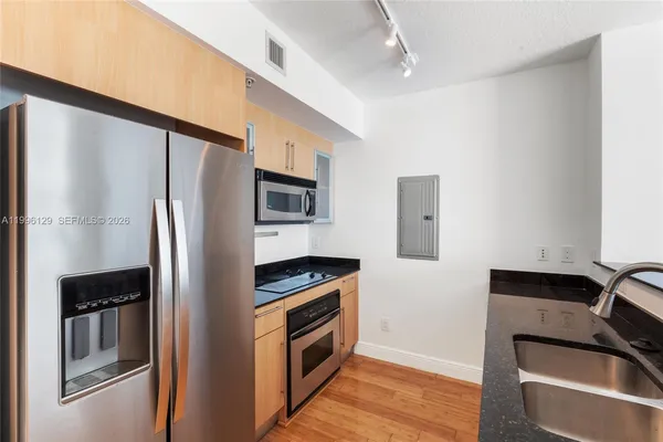 a kitchen with stainless steel appliances a refrigerator stove and sink