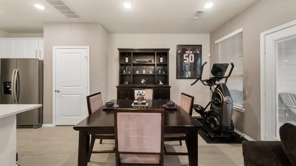 a view of a workspace with furniture and a kitchen