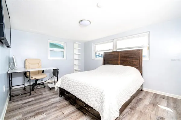 a bedroom with a bed a table and chair