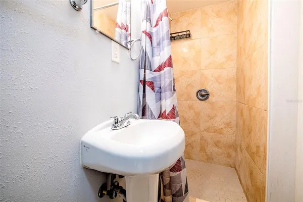 a bathroom with a sink and mirror with toilet