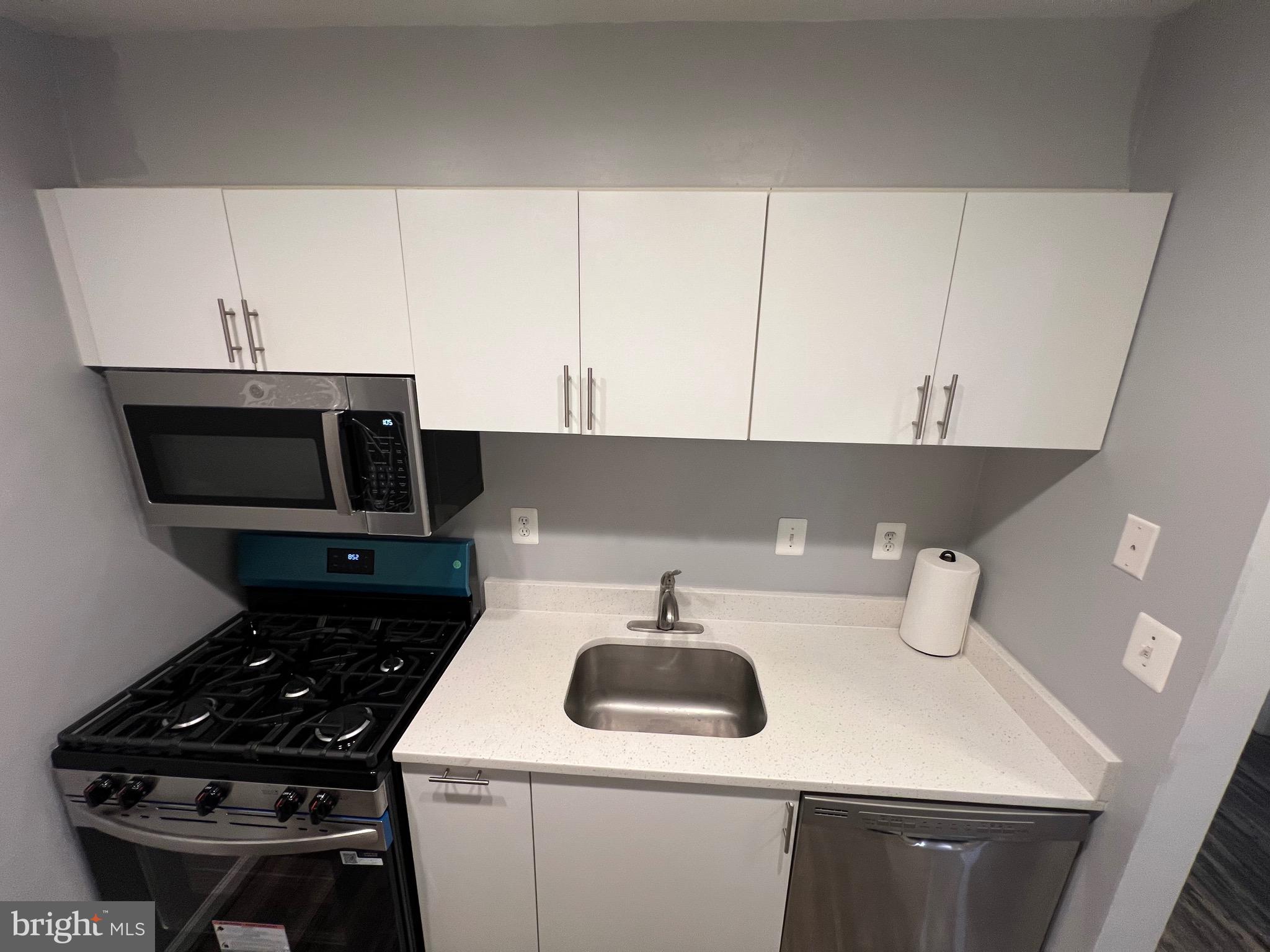 5918 Cove Landing Road, Unit 204 Burke, VA 22015 - Photo 13 of 39 a kitchen with a sink a stove and cabinets