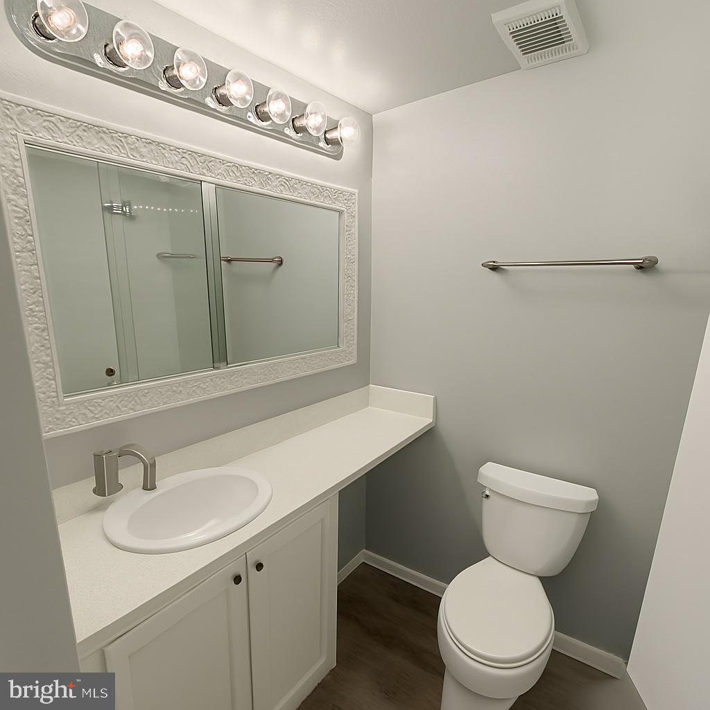 5918 Cove Landing Road, Unit 204 Burke, VA 22015 - Photo 15 of 39 a bathroom with a toilet sink and mirror