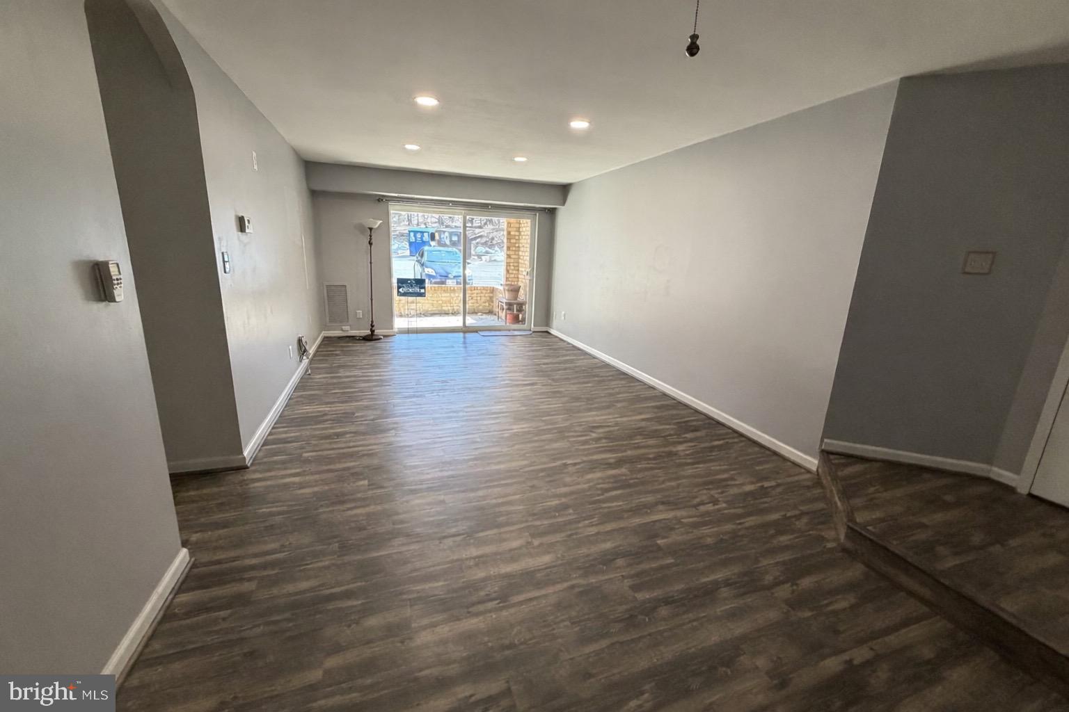 5918 Cove Landing Road, Unit 204 Burke, VA 22015 - Photo 27 of 39 an empty room with wooden floor and windows