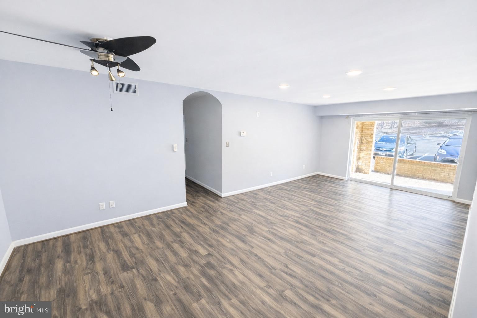 5918 Cove Landing Road, Unit 204 Burke, VA 22015 - Photo 28 of 39 wooden floor in an empty room with a window
