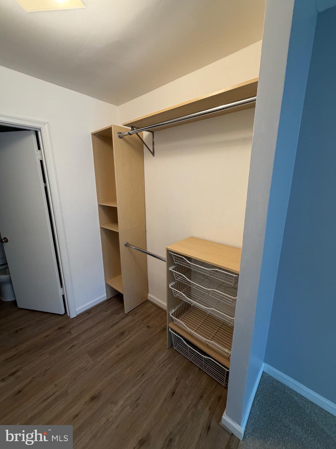 5918 Cove Landing Road, Unit 204 Burke, VA 22015 - Photo 39 of 39 a view of walk in closet with wooden floor and stairs