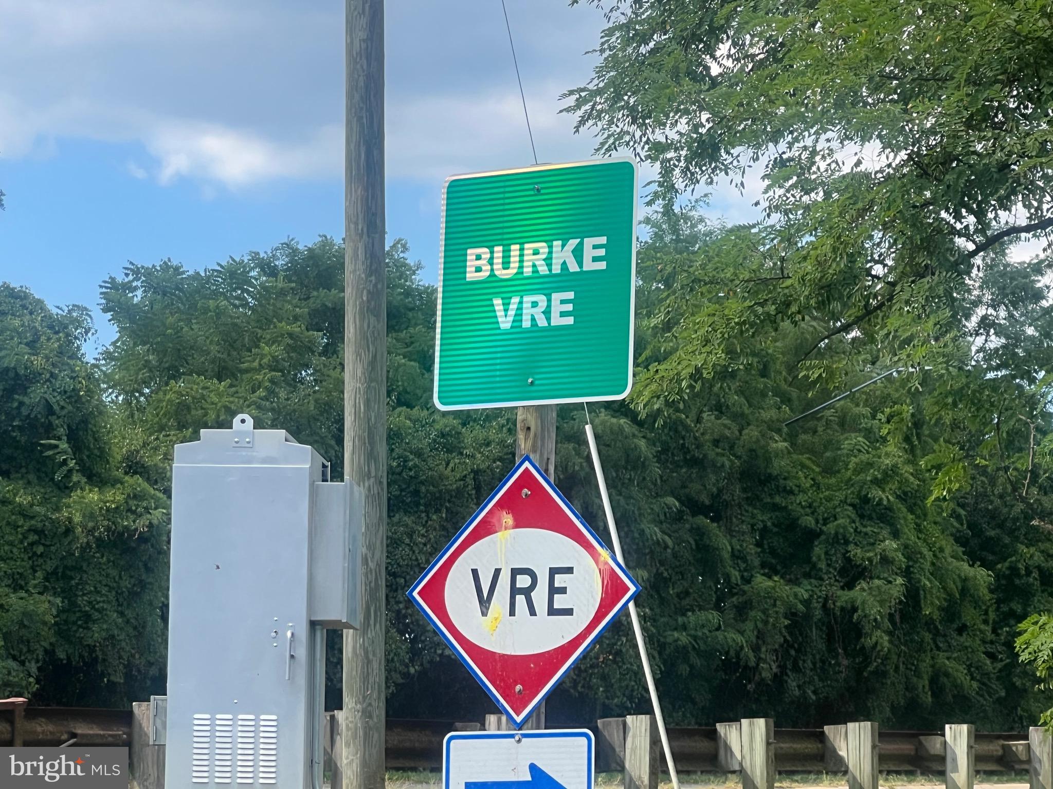 5918 Cove Landing Road, Unit 204 Burke, VA 22015 - Photo 4 of 39 a sign that is on a brick wall with a small yard