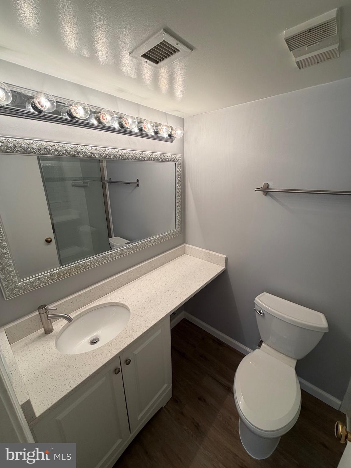 5918 Cove Landing Road, Unit 204 Burke, VA 22015 - Photo 46 of 50 a bathroom with a toilet sink and mirror