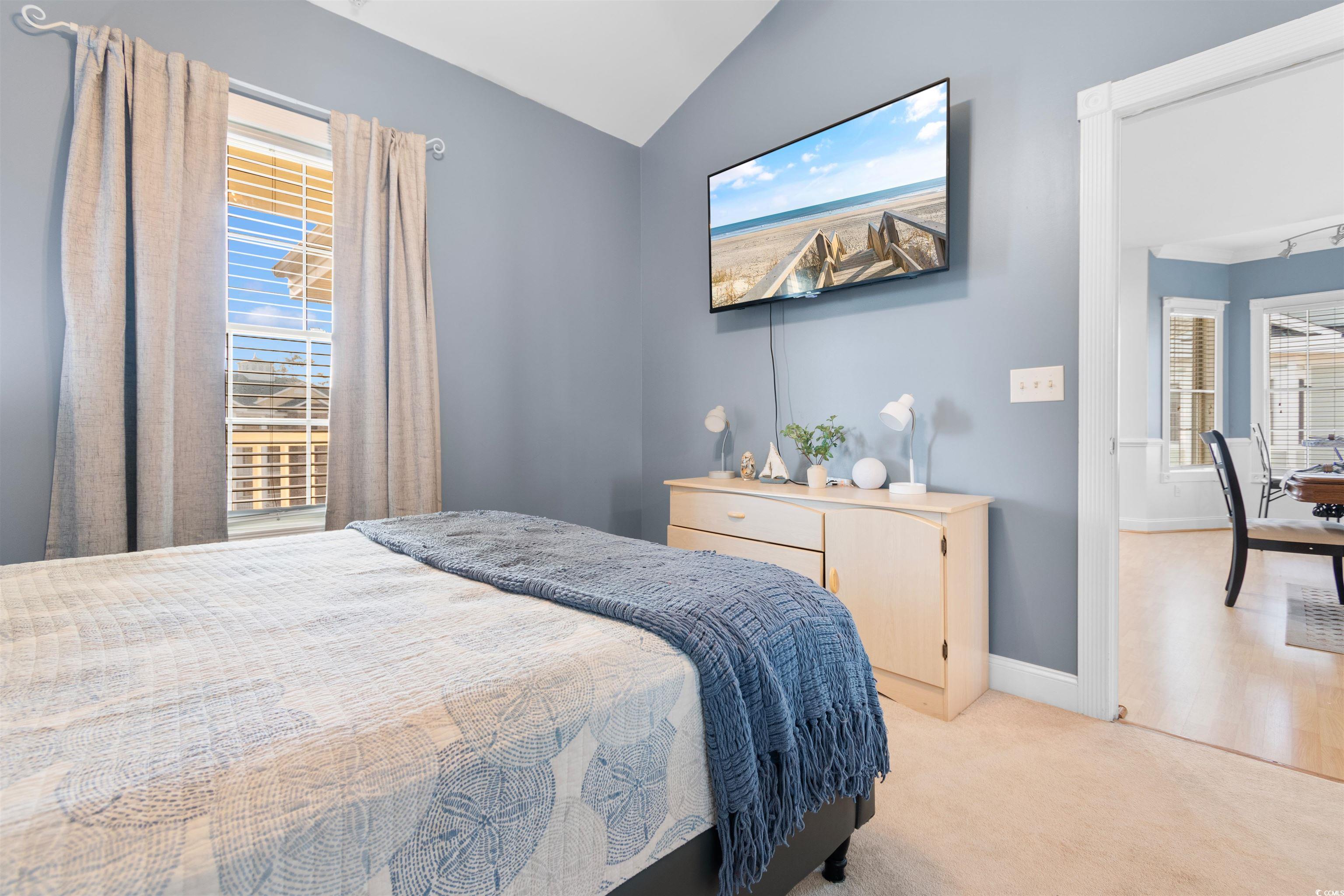 4891 Luster Leaf Circle, Unit 401 Myrtle Beach, SC 29577 - Photo 13 of 35 Bedroom featuring lofted ceiling and carpet