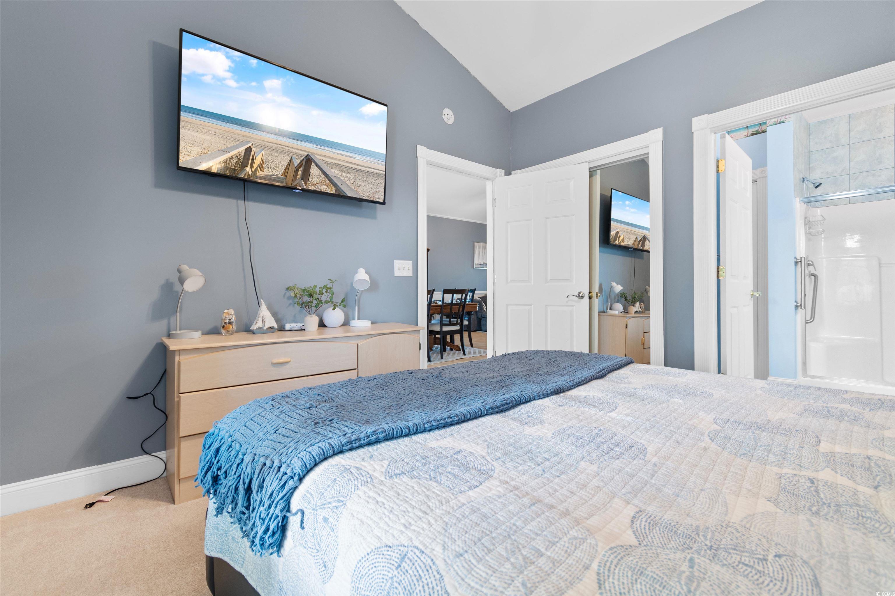 4891 Luster Leaf Circle, Unit 401 Myrtle Beach, SC 29577 - Photo 14 of 35 Carpeted bedroom with baseboards and vaulted ceiling
