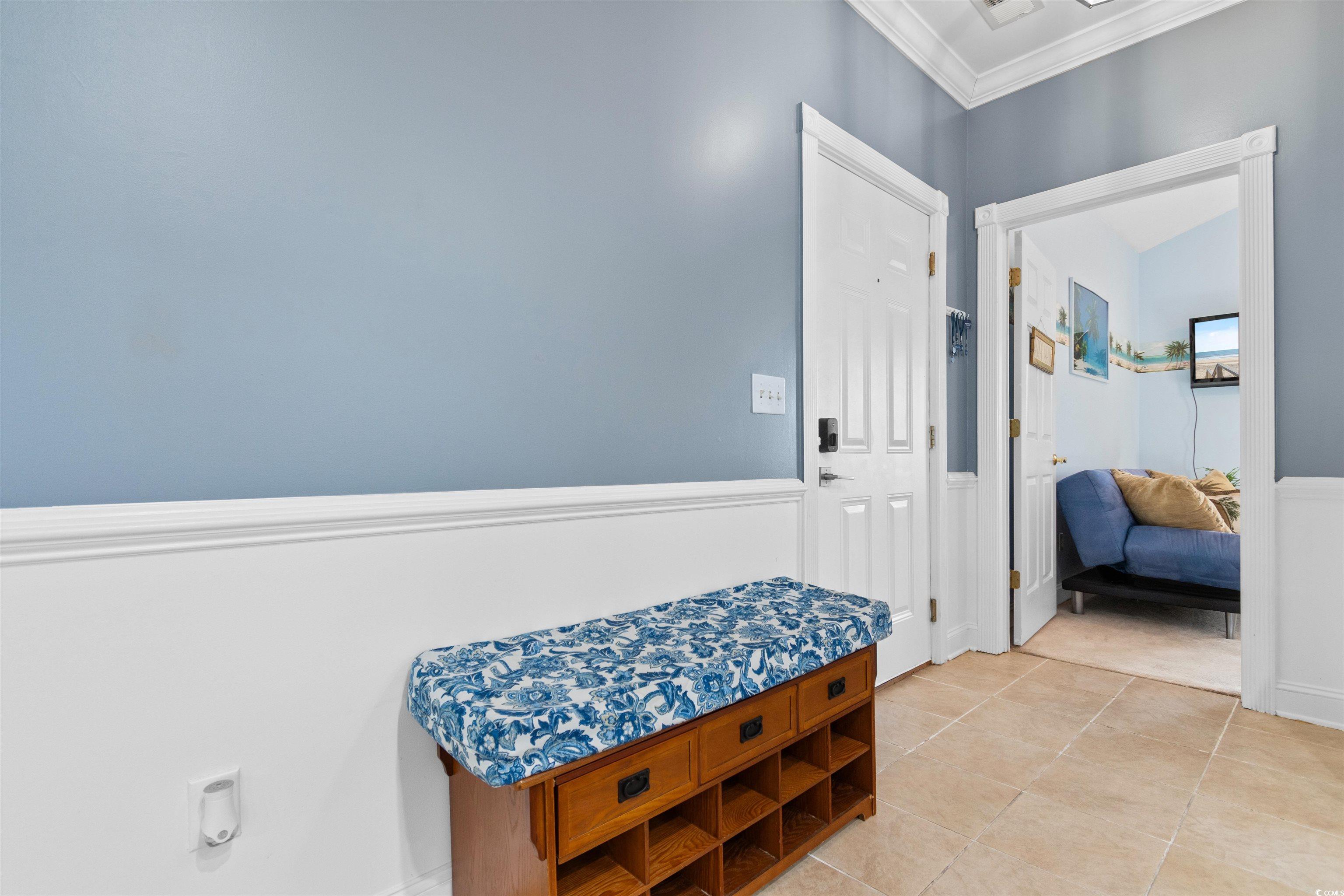 4891 Luster Leaf Circle, Unit 401 Myrtle Beach, SC 29577 - Photo 16 of 35 Hallway featuring crown molding and light tile patterned floors
