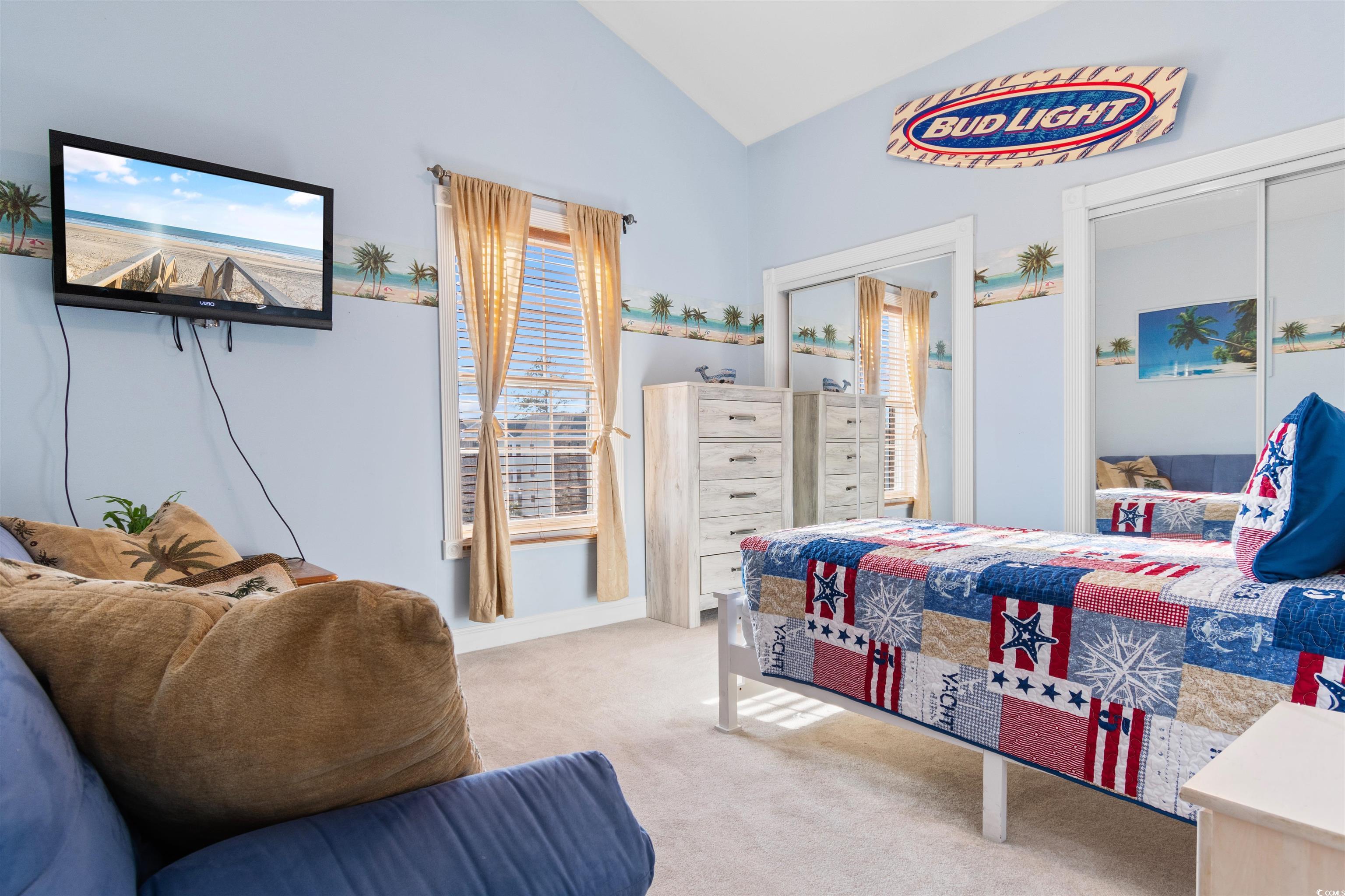 4891 Luster Leaf Circle, Unit 401 Myrtle Beach, SC 29577 - Photo 21 of 35 Bedroom with light colored carpet, ceiling fan, and lofted ceiling