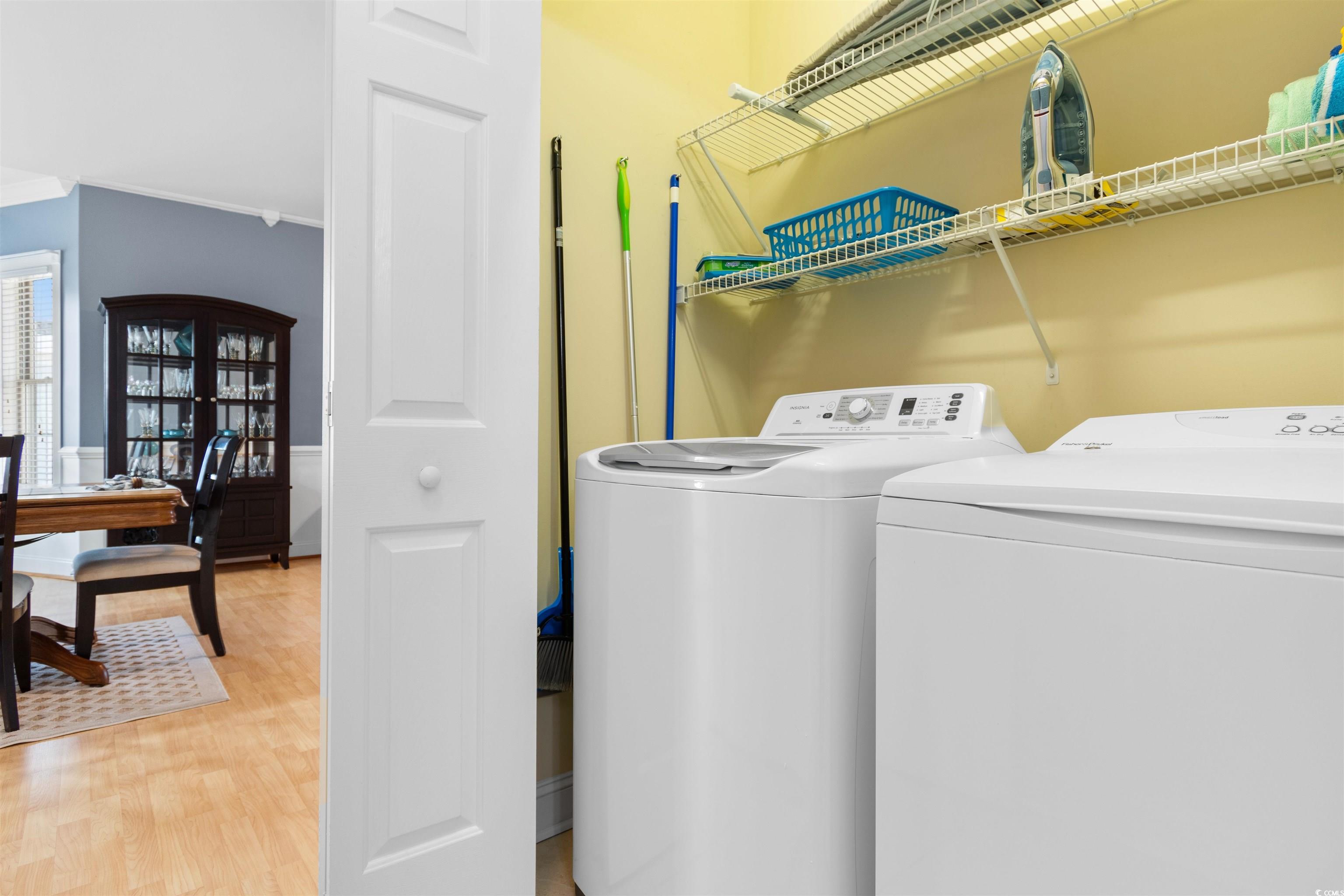 4891 Luster Leaf Circle, Unit 401 Myrtle Beach, SC 29577 - Photo 25 of 36 Washroom with light wood-style flooring and washing machine and dryer