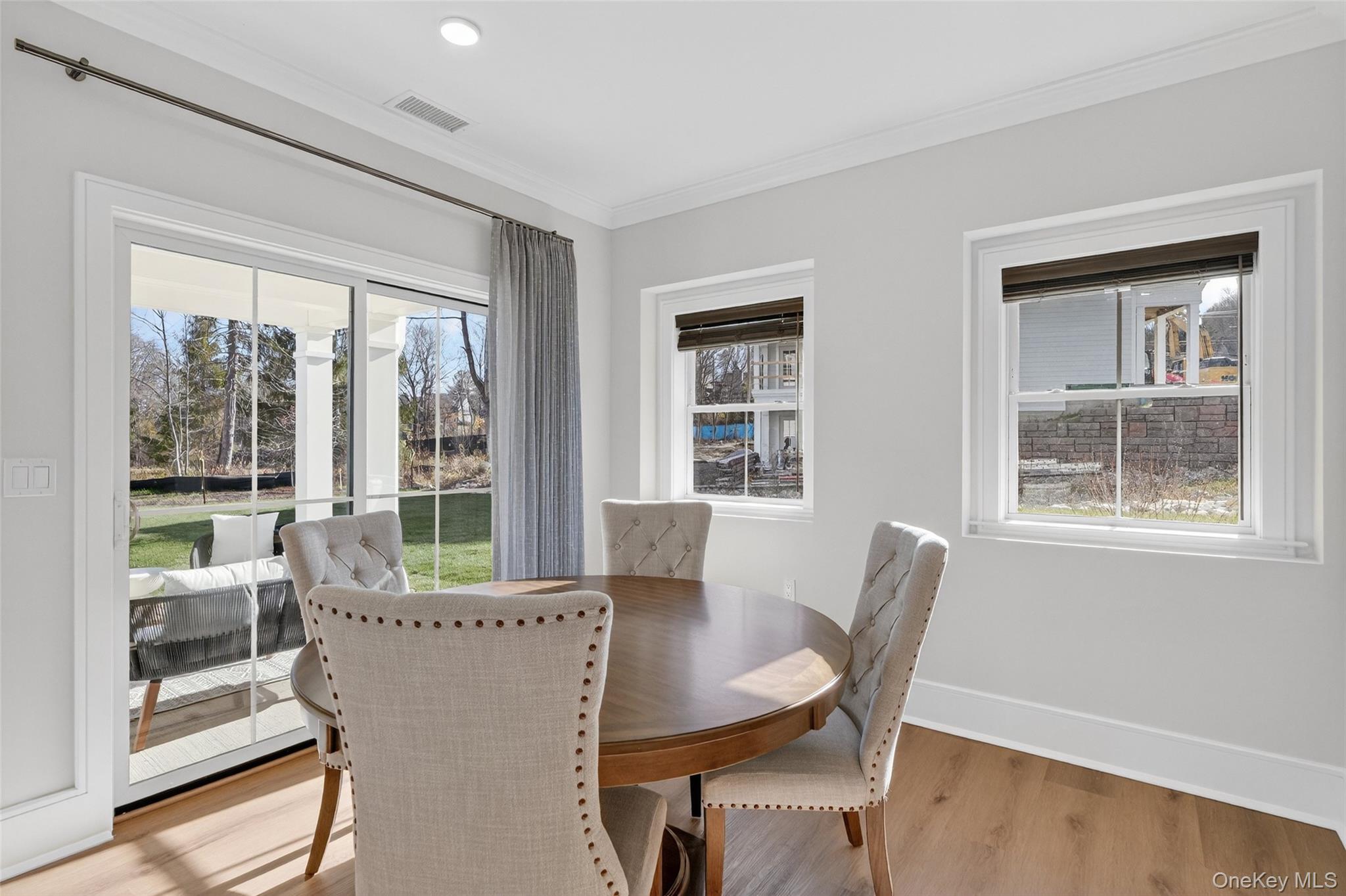 1806 Soundview Court Yorktown Heights, NY 10598 - Photo 34 of 39 a view of a dining room with furniture large windows and wooden floor