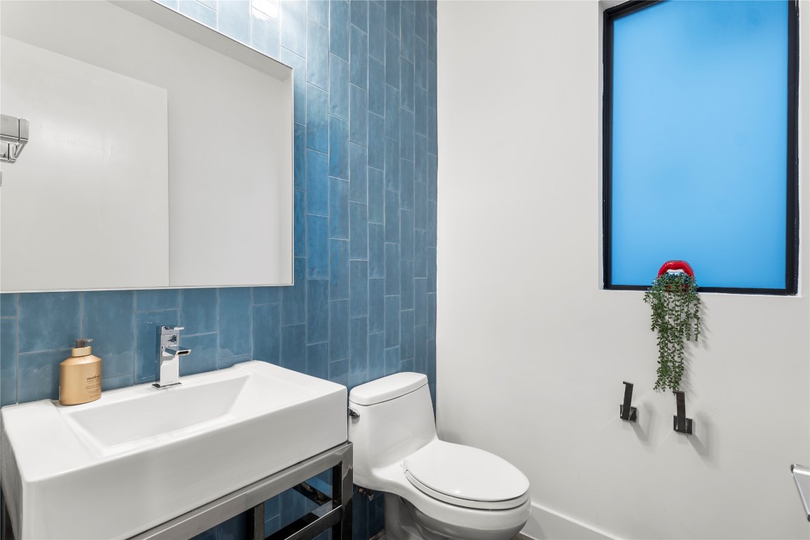 1105 East 12th Street Austin, TX 78702 - Photo 10 of 28 a bathroom with a sink a toilet and a mirror